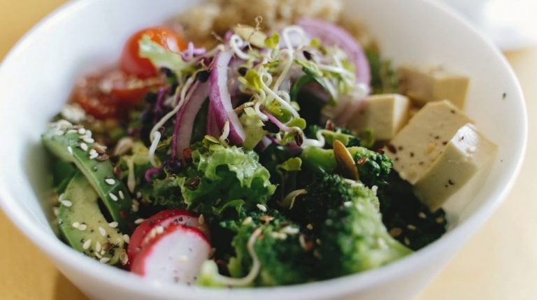 Delicious vegan meal, bowl with avocado, radish, broccoli, tofu
