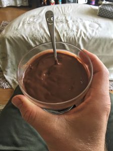 Chocolate pudding with a smiley spoon