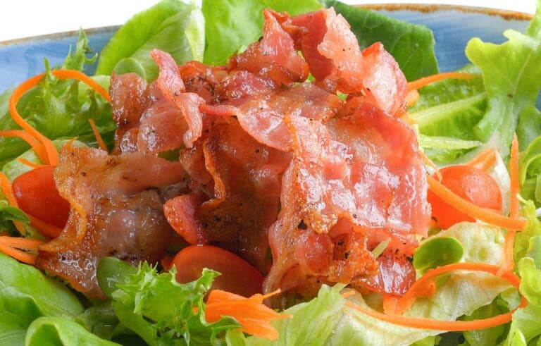 bacon salad in plate on white background
