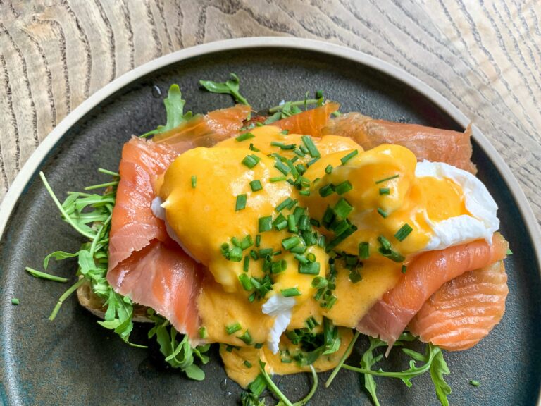 Healthy breakfast or brunch in a cafe. Eggs benedict poached eggs with smoked salmon rocket on toast
